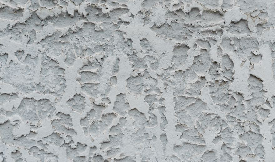 A close up of the wall with white paint.
