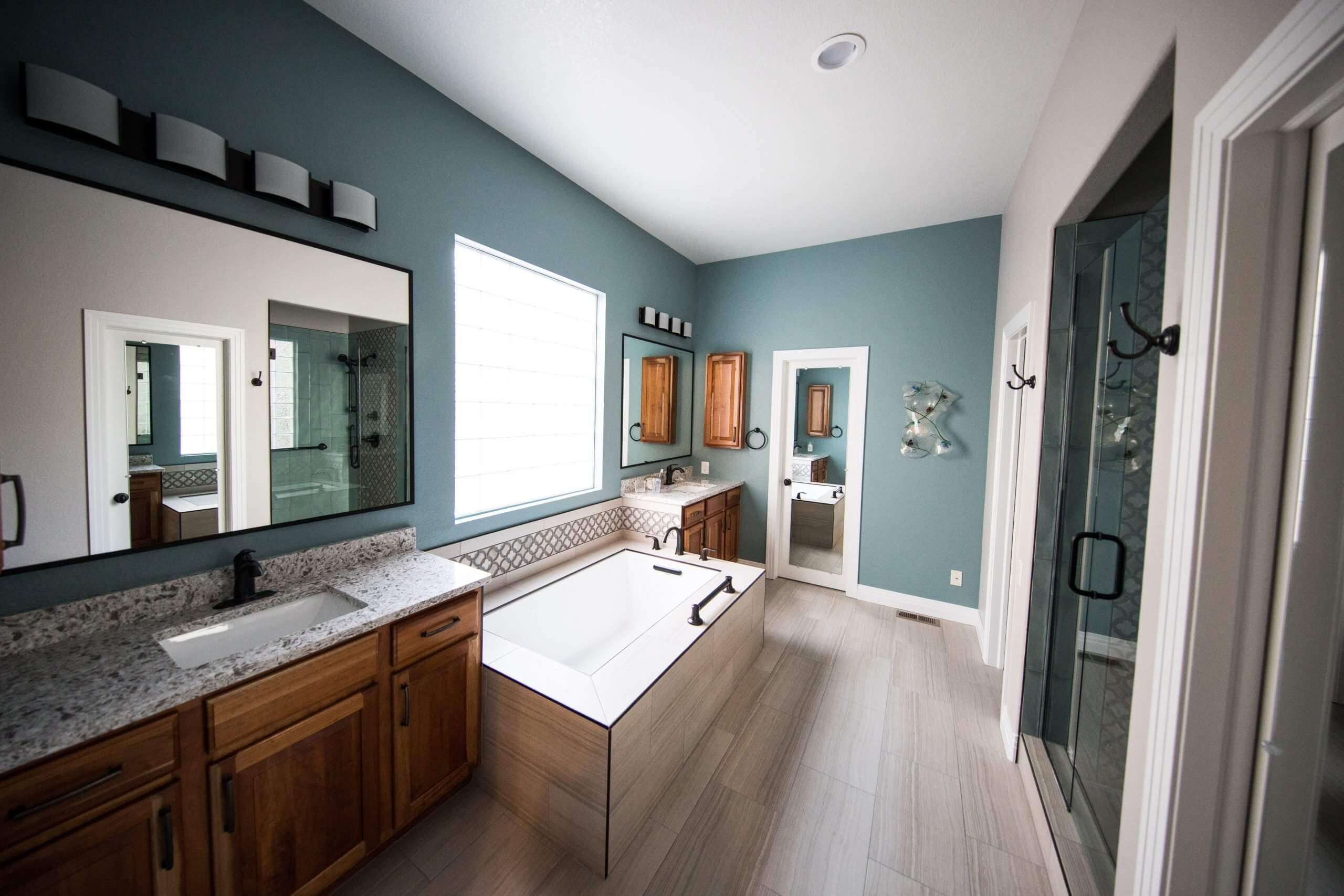 A bathroom with a large tub and wooden cabinets.